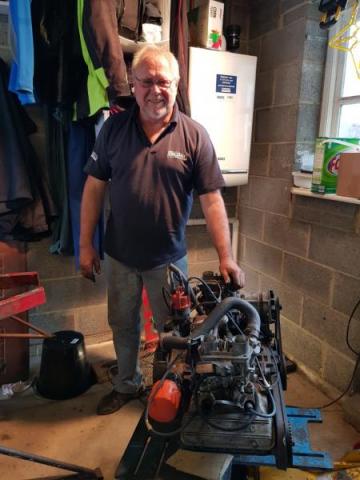 Picture of Brian Brown with the Engine out of the car 